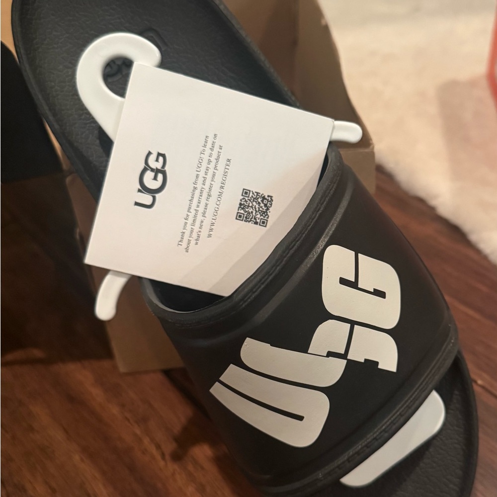 By UGG- authentic , black slide sandals.  Beach, casual or running errands. NWT